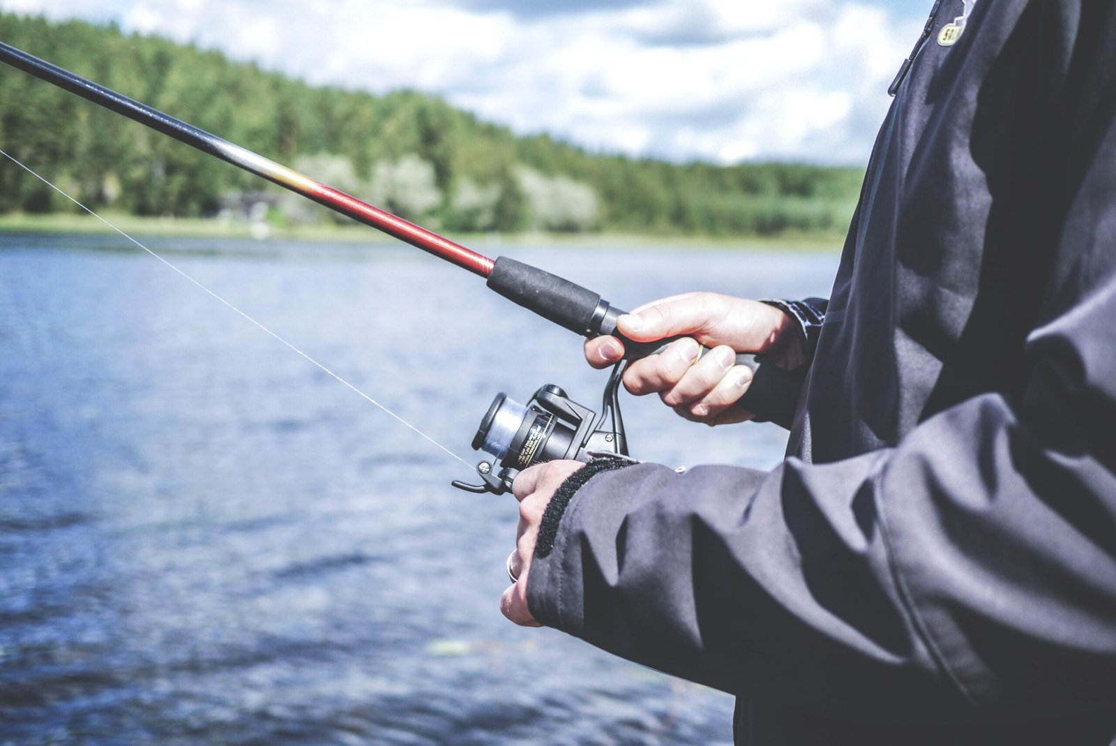 An angler fishing beside a lake